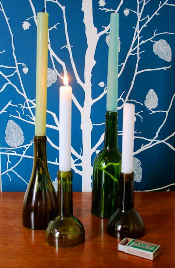 DIY Wine Bottle Candle Holders. Cut the wine bottles at different heights to create these cool candle holders. They are perfect for dinner decoration! 