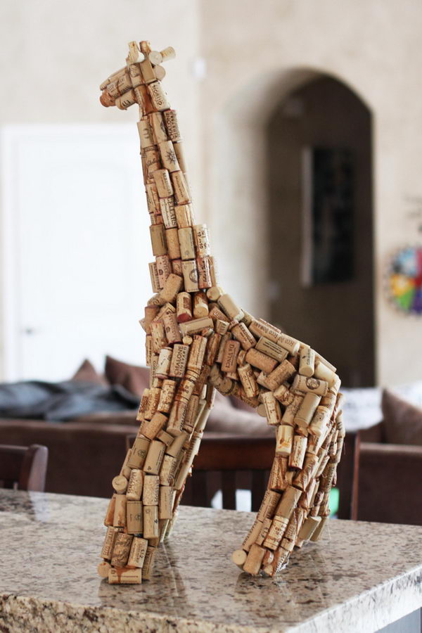 Wine Cork Giraffe Sculpture. This huge wine cork sculpture was created using just corks, newspaper and wire hangers. It makes a great decor for your bar area.