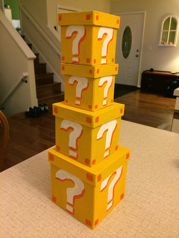 Super Mario Style Question Mark Boxes. These cardboard boxes are painted yellow with the yellow color first and question marks. They are used for a super mario baby shower.