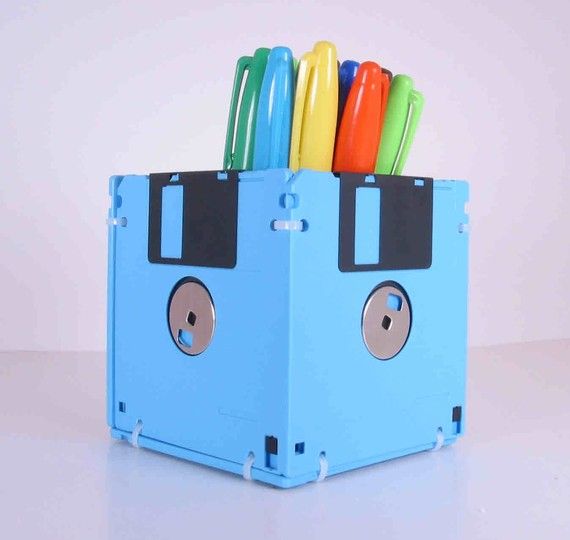 Floppy Disk Pen and Pencil Holder. This item is manufactured out of sky blue recycled floppy disks. A perfect gift for a co-worker or that special geek in your life.