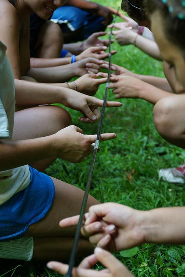 Tent Pole Game Team Building Activities. Great Activity to do with older kids. Everyone in the group has to keep 2 fingers on the tent pole at all times. The goal is to bring the pole off the ground to a certain height without anyone taking their fingers off the pole. (Could go from a certain height then to the ground.) If someone's finger comes off, the group must re-start.
