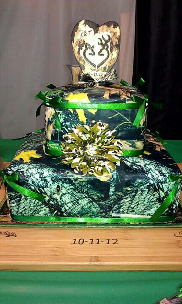 Camouflage wedding cake with an orange flower and ribbon.