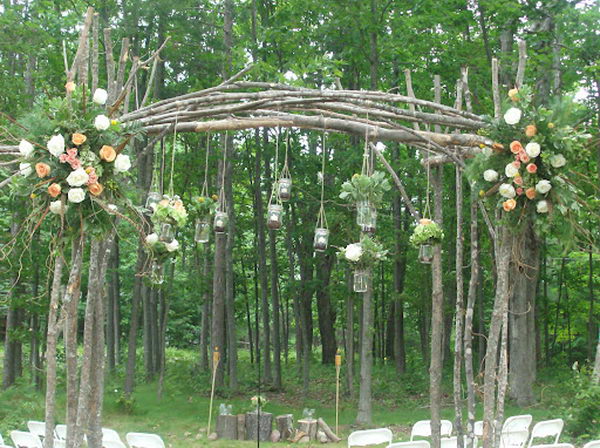 Mason Jars Wedding Arch. Hanging mason jars with candles and flowers is a great inexpensive idea for an outdoor wedding.