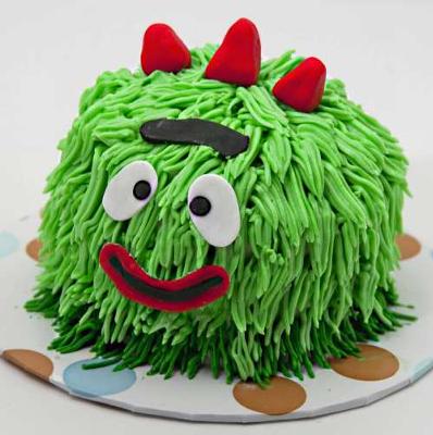A Yo Gabba Gabba Cakee with vanilla icing in the shape of Brobee with icing hair and fondant details.