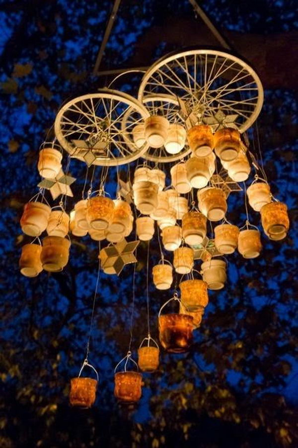 Bottle Chandelier. It's cool to use wire, candles, jars and bicycle spokes to create a gorgeous bottle chandelier for your backyard.