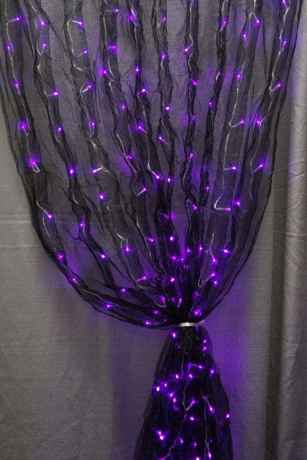 LED light Curtain. Black fabric sash and purple LED lights together makes for one really cool curatin decoration.