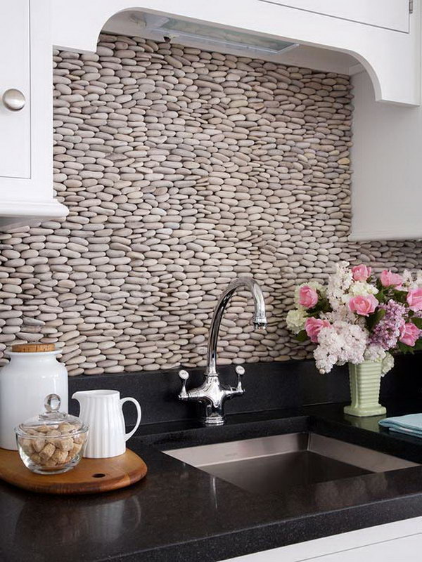 Stacked pebbles for backsplash. Not only protect the walls from staining, but also add a decorative touch to your kitchen design.