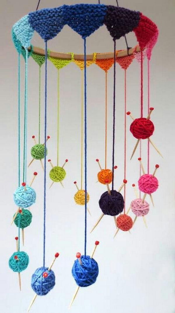 Knit some tiny bunting to go round a wooden hoop and suspend all the little balls. The wind chine craft requires minimal knitting but is a fun project to start off with.