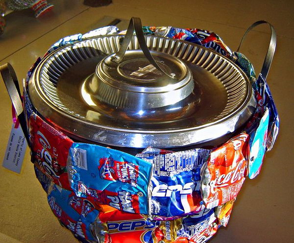 Container made from recycled soda cans. After drinking soda from aluminum cans, you can recycle your soda cans to create interesting projects instead of tossing the empty cans into the garbage or recycling bin.