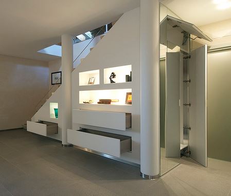 under stairs closet. The space under a staircase can be used to keep everyday clutter out of the way.