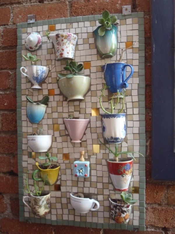Teacups mosaic board. It allows plants to extend upward rather than grow along the surface of the garden. Doesn’t take a lot of space and look so beautiful at the same time.