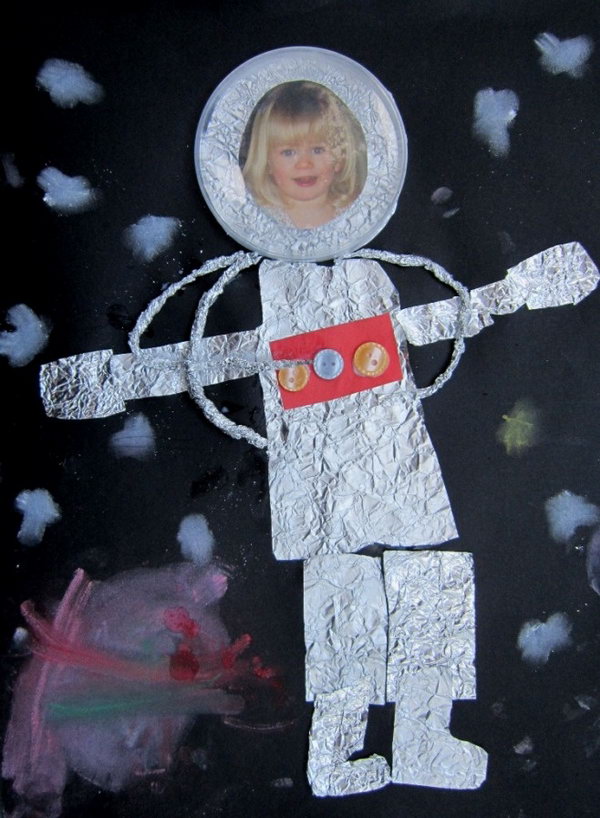 Astronaut craft made from Kitchen foil, buttons, photo, clear lid, coloured card and soft pastel. 