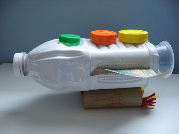 Recycled rocket craft made from juice bottle, toilet paper rolls and bottle caps. 