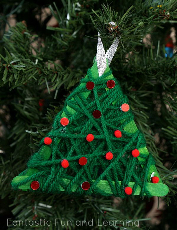 Make these yarn wrapped Christmas tree ornaments with kids and place them on your Christmas tree. 