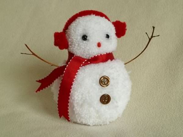 Create pom poms for the base, then decorate the snowman with beads, buttons, felt or ribbon, 