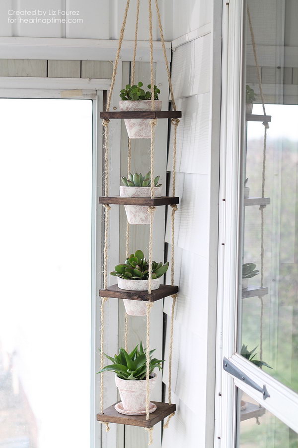 DIY Vertical Plant Hanger tutorial. This project makes a beautiful display for your potted plants without taking up a ton of room. Perfect for small balcony garden. 