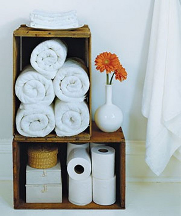 Old wood wine crates have a natural vintage charm, and make smart holders for extra toilet paper and rolled bath towels. 