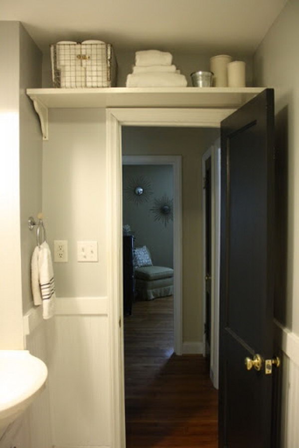 To maximize space in the bathroom add a shelf over the door to store extras like toilet paper and extra towels.  