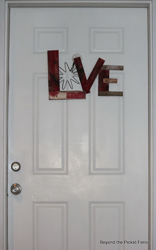 A cute LOVE sign door decorating idea for Valentine's day. A piece of a big spring was used for the letter O.  