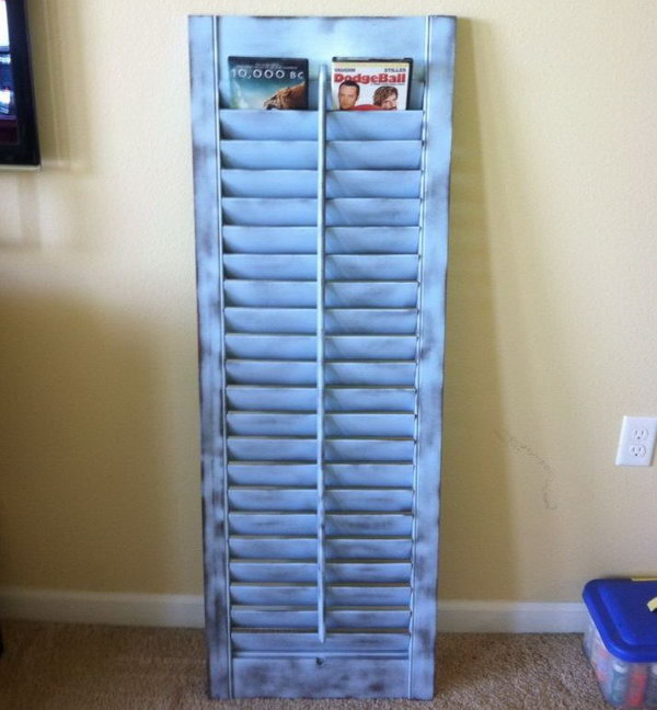 This old shutter was painted and repurposed to be a DVD holder. 