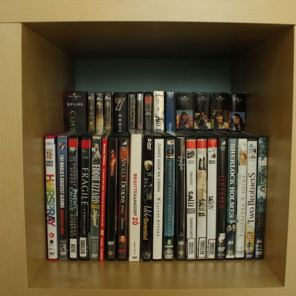 Double DVD storage space by placing a raised shelf in the back of a bookcase. 