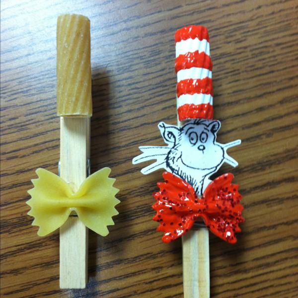 Clothespin craft inspired by Dr. Seuss' book The Cat in the Hat. It provides kids with a fun way to display papers and projects on the refrigerator at home or on a school bulletin board. 