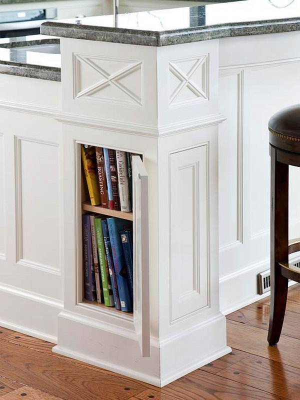 Column-style corners on this kitchen island are more than just decorative. Opening the recessed panel with a push latch reveals hidden cookbook storage. 