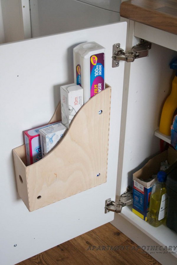 Screwing a magazine file holder to the inside of kitchen cupboards adds space to store more bulky items like chopping boards, cleaning products etc. 