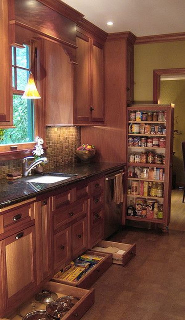 Narrow drawers underneath the cabinetry provide storage for narrow items such as cooking and pizza trays. 