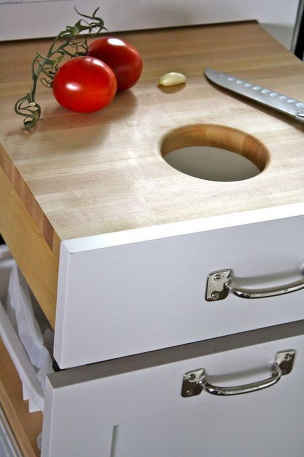 Put the cutting board in a drawer just over the trash can, so you can just scrape the unwanted scraps right in. 