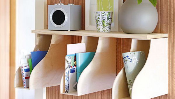 Put a few magazine holders under a shelf and you can create a space for mail and accessories. 