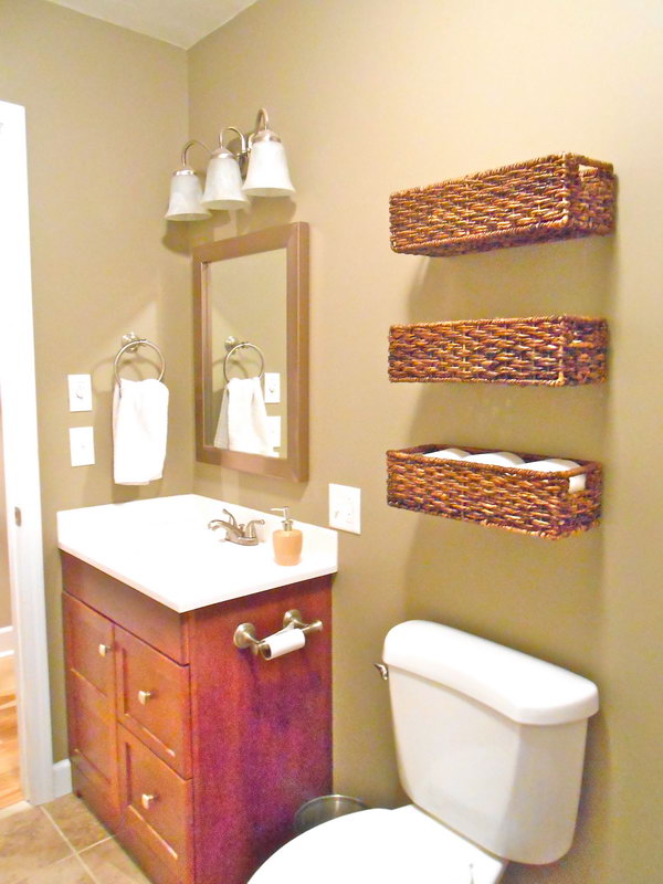 Use the baskets over the toilet to store band-aids, extra toilet paper and other first aid stuff. These baskets are not only lovely, but also functional. 