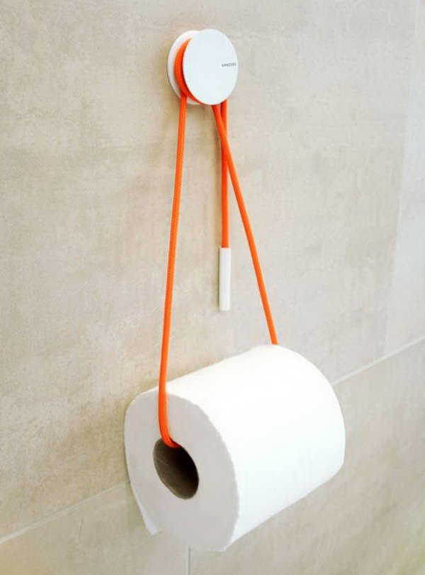 Use a rope to hold your toilet paper storage roll, and add a dash of color to the bathroom. A simple but functional toilet paper storage idea.  