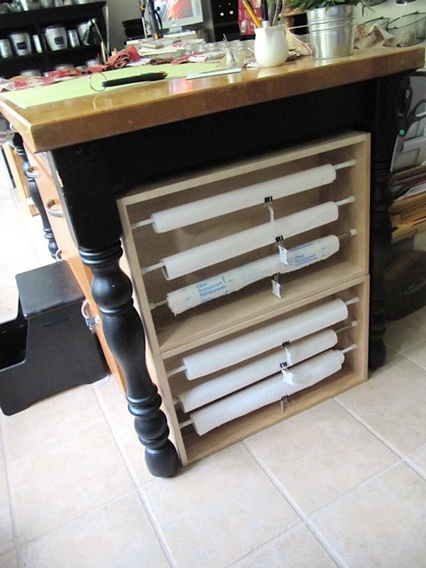 Build paper rolls organizers with tension rods and old drawers that fit between the legs of table. Label your rolls so you can tell what's what. 