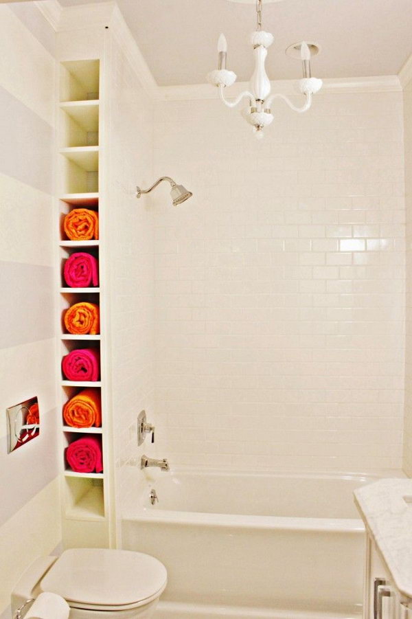 A nook by the tub. Create a ceiling-height rack between wall and tub. The space may be small but they’re perfect for storing rolled towels. 