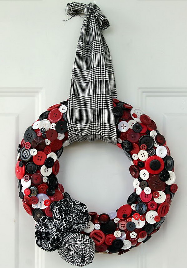 Upcycled Button Wreath. A cute wreath made from a bunch of colored buttons and decorated with matching fabric flowers. 