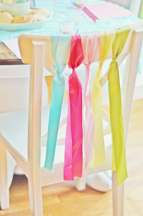 Tie the ribbon to the backs of the chairs. It's a simple yet effective way to decorate dining room chairs for your Easter spring party. 