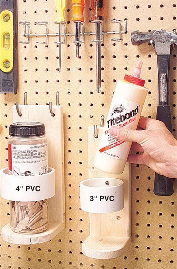 PVC pipe and wood bracket mounted to pegboard for garage storage. Organizing garage can be a lengthy and costly process, but it will save time and eventually money.