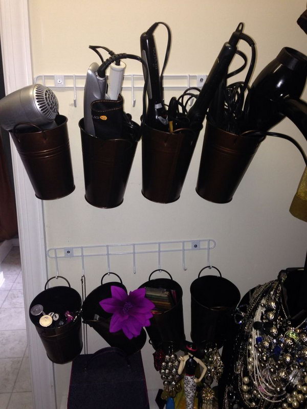 Bucket Storage. Hang the metal buckets on the wall to organize hair dryers and curling irons. You can also label these buckets to easily find what you want. 