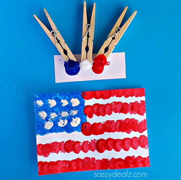 Pom-Pom American Flag Painting Craft for Kids. Sometimes using a regular paintbrush can get boring so grab some clothespins and pom-poms to make a cool American flag craft. This is fun and easy for kids to do on the 4th of July or Memorial Day. 