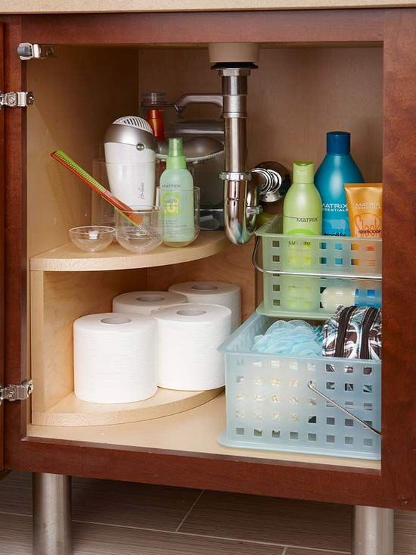 Install a curved multitier storage unit along the undersink plumbing. Free up space for everyday items in the vanity of the bathroom. 