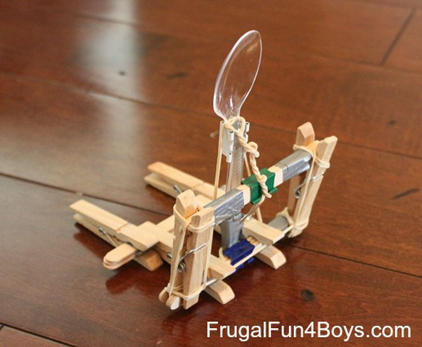 Siege Catapult. You need the materials like, clothes pins, craft sticks, binder clips, rubber bands, duct tape, and a plastic spoon to build this awesome catapult.