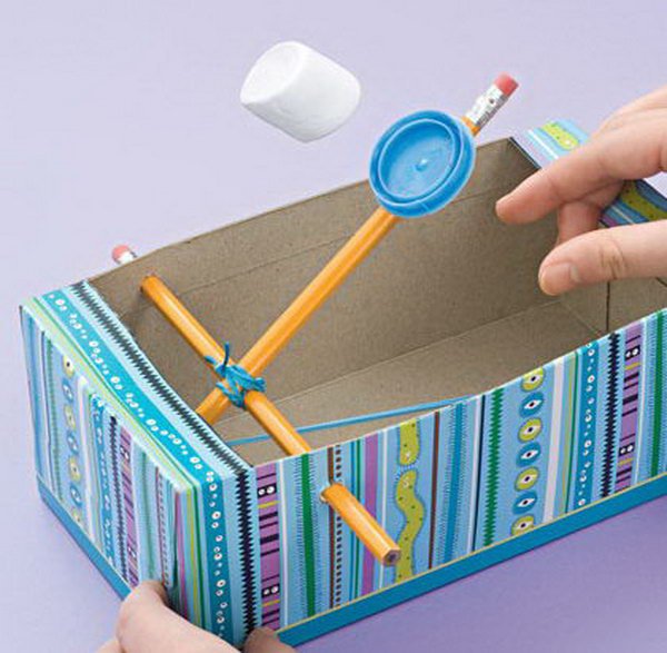 Recycled Shoe Box Catapults. Shoe boxes lying around your house are not just trash. Instead of just throwing them away, you can reuse them in fun crafts and convert them into a fun toy for you lovely kids just with 2 pencils, a rubber band, and a milk cap. Learn how to do it. 
