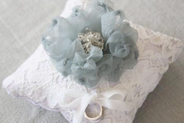 Fabric Flower Ring Pillow: Add the feather and fabric flower embellishments to the hand sewn pillow cover. This stunning DIY flower ring pillow would be perfect for your wedding decoration. See the tutorial 
