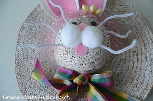 Bunny Easter Hat Decoration. Glue the ears from the form sheet of white and pink. Make the whiskers using pipe cleaners, stick the mouth and apply 3 pom poms above the whiskers. Finish it off with the colorful ribbon bow. This can be used to decorate the door too.