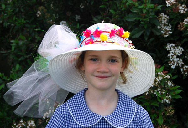 Flower Wreath Easter Hat. Decorate your Easter hat with a beautiful flower wreath, add some flowers, butterflies, beadings and tulle bows to decorate it. It can’t be prettier.
