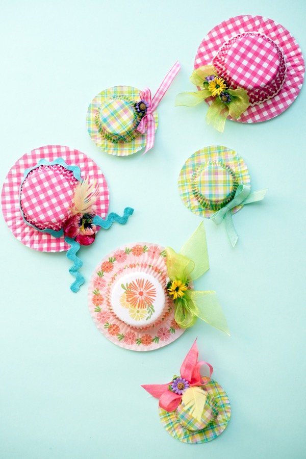 EASTER HAT FAVORS DIY. Glue cardstock to the cupcake liner with beautiful patterns to make it stronger. Glue the cupcake liner filled with candy to the one with cardstock. Attaching some decorations such as ribbons or bows to make it more beautiful.