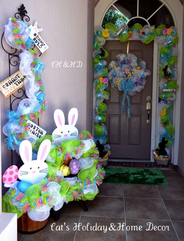 Easter Basket Door Decor. This well-refined Easter decor starts with mesh in white and lime green, add the ribbons as the base. Put two baskets filled with treats for children at two sides such as chocolate bunnies, rolled candy, Easter eggs and jelly beans.