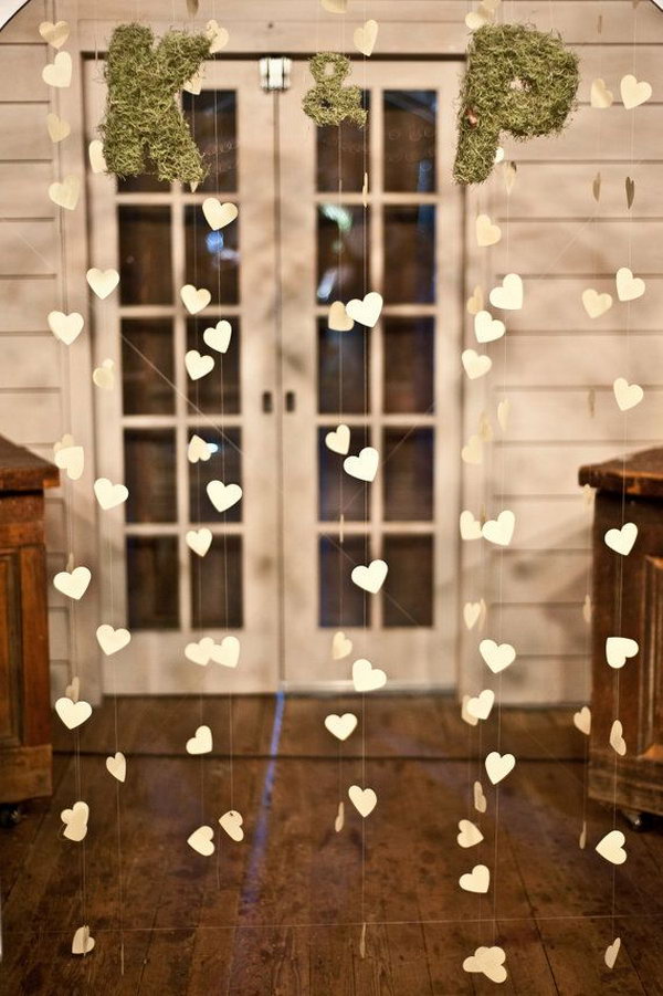 Engagement Party Heart Garland. Thread all the heart shaped cards into a garland. You can paint them in your favorite color. Fasten the moss letters at the top. You can choose 2 letters from the first letter of the couple’s last name. It adds a fresh flavor to this garland.