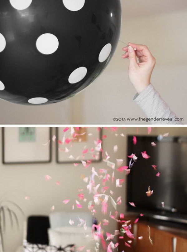 Balloon Confetti Gender Reveal Party. Hang black polka dot balloons to make the great discovery with colorful confetti inside. Discover the gender based on the color of the confetti by popping the balloons.